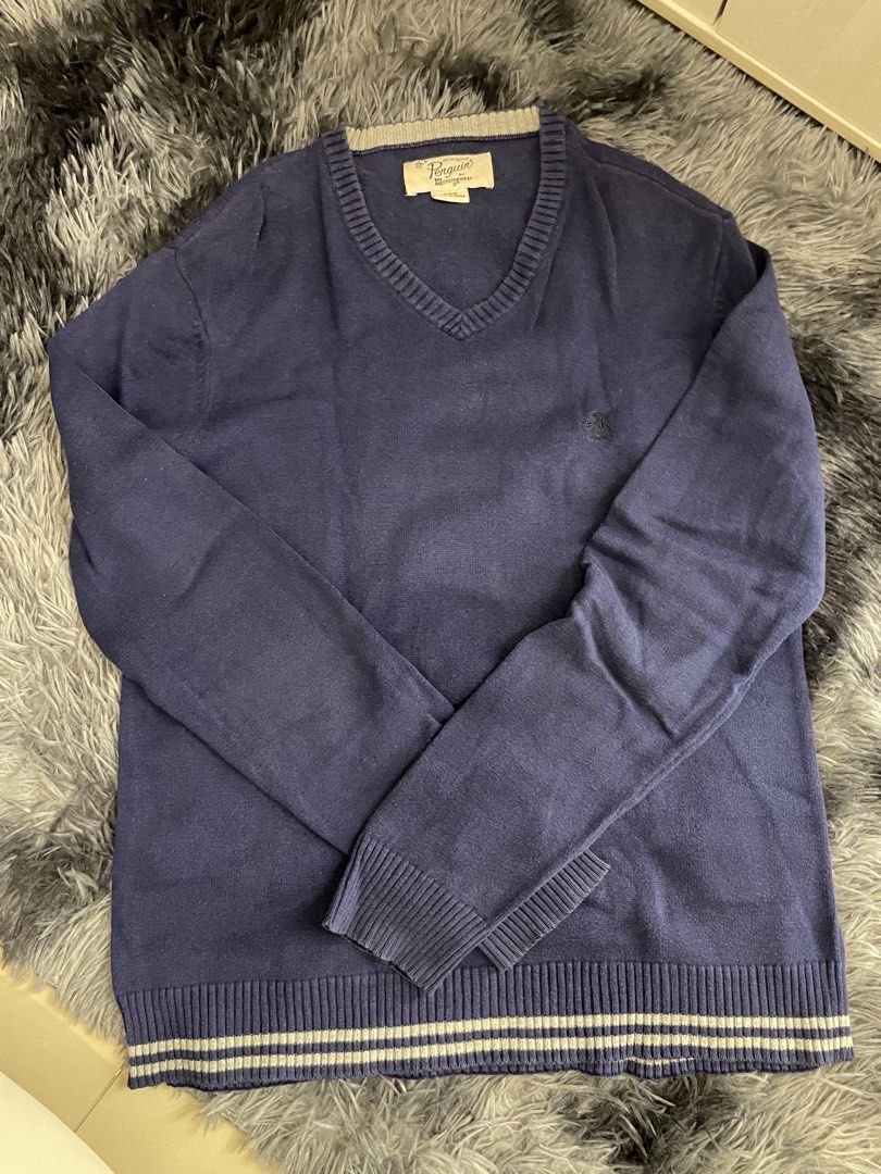 Original Penguin, V-Neck Navy Blue Sweater (Category: Coats, Jackets and Outerwear) located in Quezon City. Submitted by izxbll_declutters (Listing ID 1441723245, Image 1). Description: - Original Penguin by Munsingwear V-neck sweater - Deep navy blue color - Signature embroidered penguin logo on chest - Ribbed cuffs and hem with subtle stripe detail - Size: Large - Perfect for layering or standalone wear.