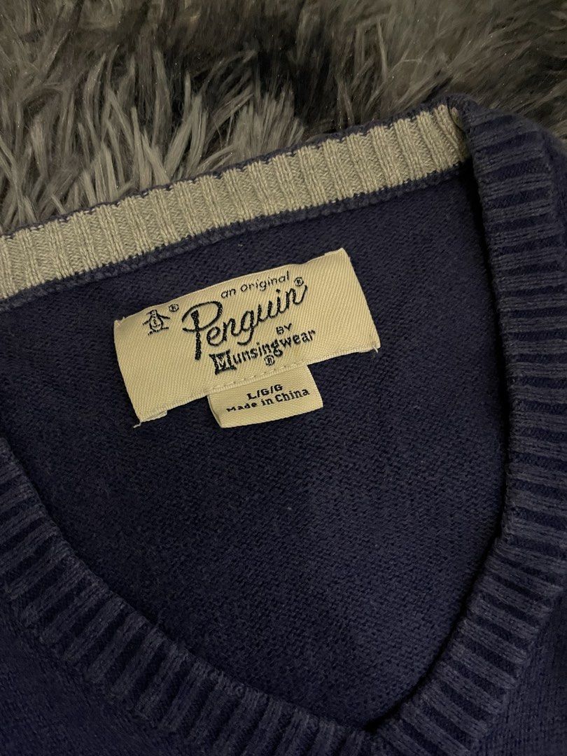 Original Penguin, V-Neck Navy Blue Sweater (Category: Coats, Jackets and Outerwear) located in Quezon City. Submitted by izxbll_declutters (Listing ID 1441723245, Image 3). Description: - Original Penguin by Munsingwear V-neck sweater - Deep navy blue color - Signature embroidered penguin logo on chest - Ribbed cuffs and hem with subtle stripe detail - Size: Large - Perfect for layering or standalone wear.