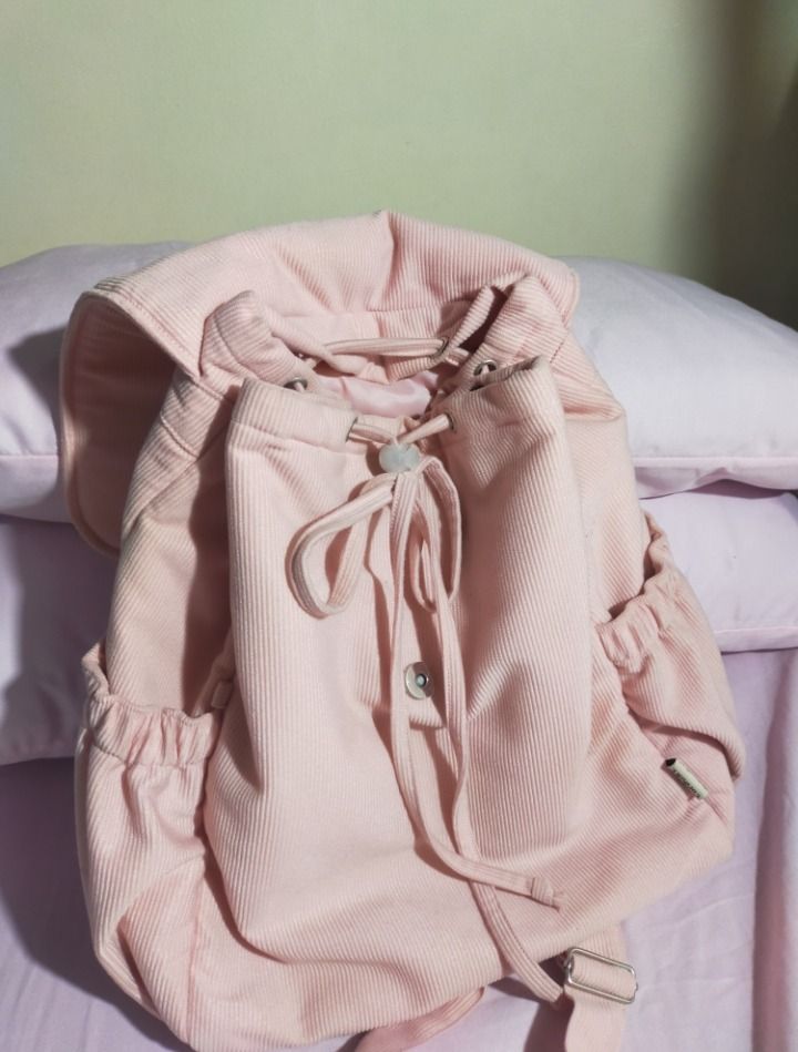 Pink Corduroy Drawstring Backpack (Category: Backpacks) located in Bulacan. Submitted by meisharet (Listing ID 1441697837, Image 2). Description: for sale‼️ ₱199 + sf (+50 if kasama cinnamorolll) RFS: shoulder bags na bet ko hahaha minsan ko lang nagamit nung first sem originally bought it for ₱473! - padded compartment - kasya 22oz tumbler sa loob and a4 files - need i-bend yellow paper sa loob.