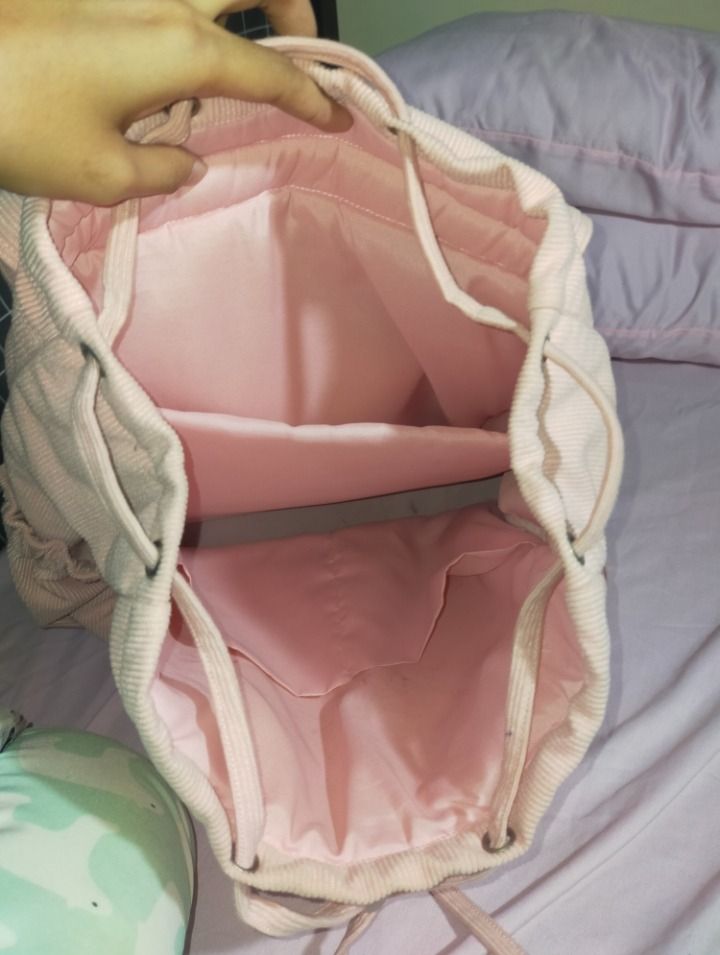 Pink Corduroy Drawstring Backpack (Category: Backpacks) located in Bulacan. Submitted by meisharet (Listing ID 1441697837, Image 3). Description: for sale‼️ ₱199 + sf (+50 if kasama cinnamorolll) RFS: shoulder bags na bet ko hahaha minsan ko lang nagamit nung first sem originally bought it for ₱473! - padded compartment - kasya 22oz tumbler sa loob and a4 files - need i-bend yellow paper sa loob.