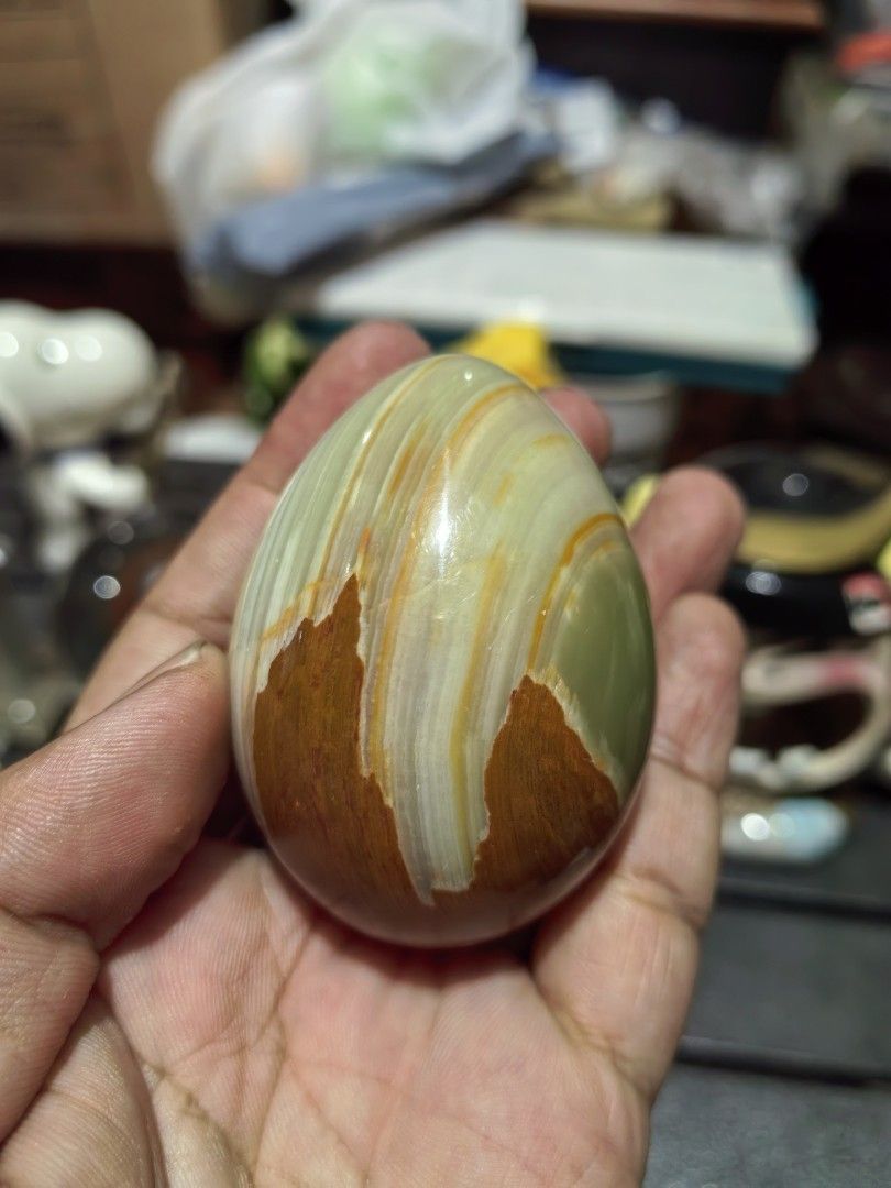 Polished Decorative Egg Green Onyx Marble (Category: Other Home Decor) located in Cebu City. Submitted by dudes_villanueva (Listing ID 1441622025, Image 1). Description: Polished Decorative Egg Green Onyx Marble 📌 Features distinct white and orange banding. 📌 Material: Natural Onyx Marble.Colors: Green, white, and orange/brown banded patterns. 📌 Finish: Polished to a smooth, glossy texture. 📌 Common Use: Decorative home or office. item. Heigh