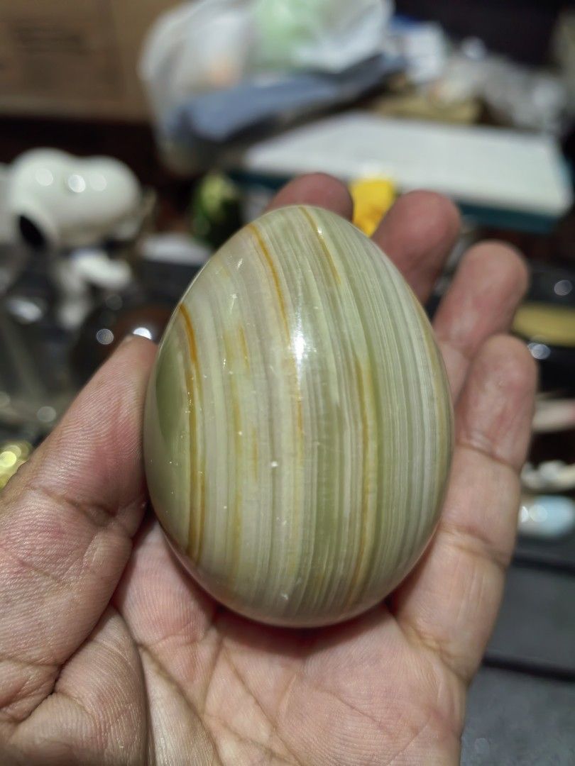 Polished Decorative Egg Green Onyx Marble (Category: Other Home Decor) located in Cebu City. Submitted by dudes_villanueva (Listing ID 1441622025, Image 3). Description: Polished Decorative Egg Green Onyx Marble 📌 Features distinct white and orange banding. 📌 Material: Natural Onyx Marble.Colors: Green, white, and orange/brown banded patterns. 📌 Finish: Polished to a smooth, glossy texture. 📌 Common Use: Decorative home or office. item. Heigh