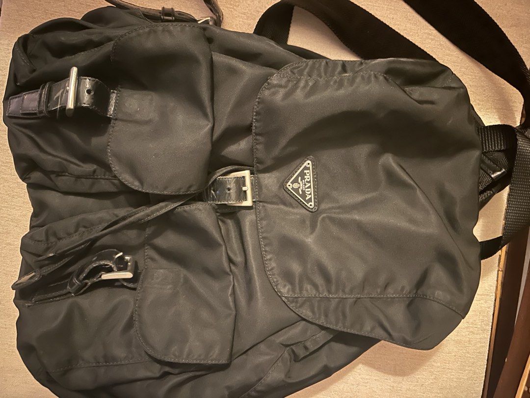 Prada Nylon Backpack Black (Category: Luxury Bags & Wallets) located in Pasig City. Submitted by preelovedby (Listing ID 1441712497, Image 1). Description: - Authentic Prada backpack - Classic black color - Durable nylon material with leather trim - Secure drawstring and buckle closure - Multiple pockets for excellent organization - Ideal for everyday use or travel.