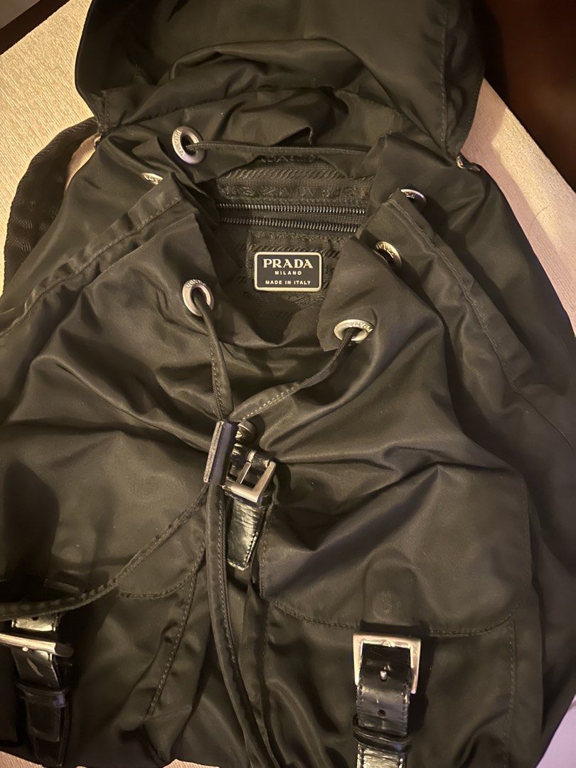Prada Nylon Backpack Black (Category: Luxury Bags & Wallets) located in Pasig City. Submitted by preelovedby (Listing ID 1441712497, Image 3). Description: - Authentic Prada backpack - Classic black color - Durable nylon material with leather trim - Secure drawstring and buckle closure - Multiple pockets for excellent organization - Ideal for everyday use or travel.