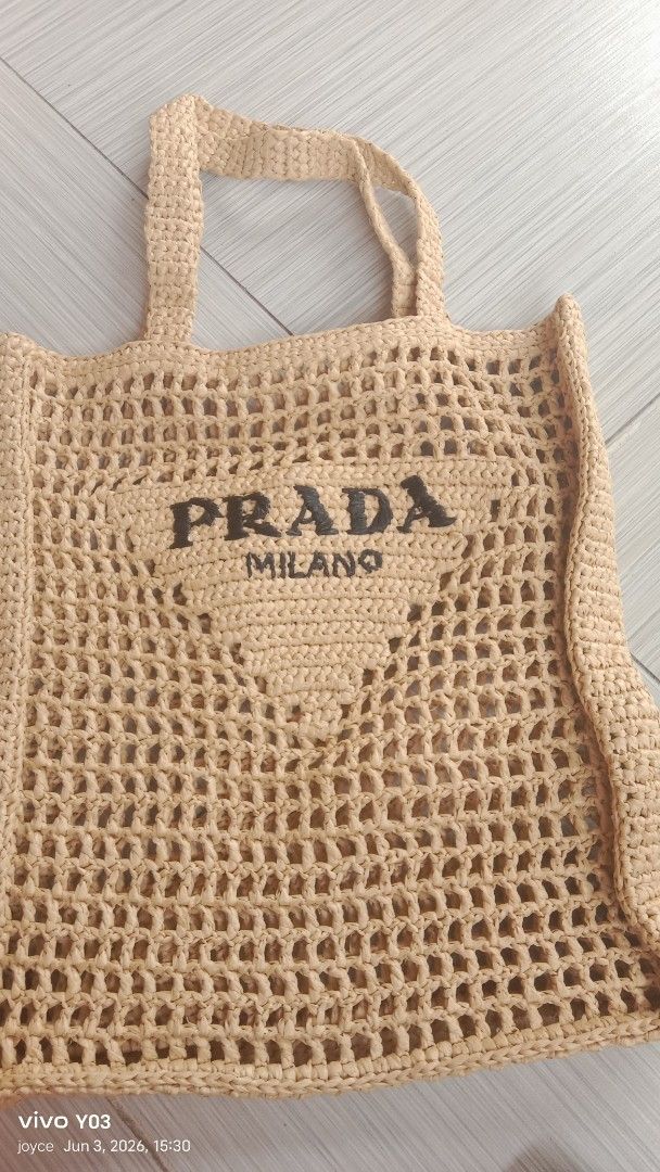 Preloved Prada Milano Crochet Tote Bag (Category: Luxury Bags & Wallets) located in Cabuyao City. Submitted by selections888 (Listing ID 1441717005, Image 2). Description: -preloved from Japan supplier -medium size -light yellow crochet tote bag - Features Prada Milano logo - Ideal for beach days or casual outings - Stylish and airy open-knit design - Crocheted handles - Roomy interior for essentials .