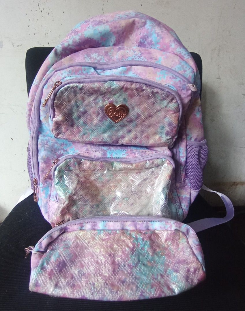 Puffy & Sparky School Bag (Category: Luxury Bags & Wallets) located in Quezon City. Submitted by cessswaaa30 (Listing ID 1441643639, Image 3). Description: a children's school bag set from the popular local brand Puffy & Sparky, specifically from one of their holographic textured pastel collections. Key Features Design & Pattern: Features a pastel purple, blue, and pink tie-dye pattern overlayed with clear quilted, iridescent front pockets. Brand