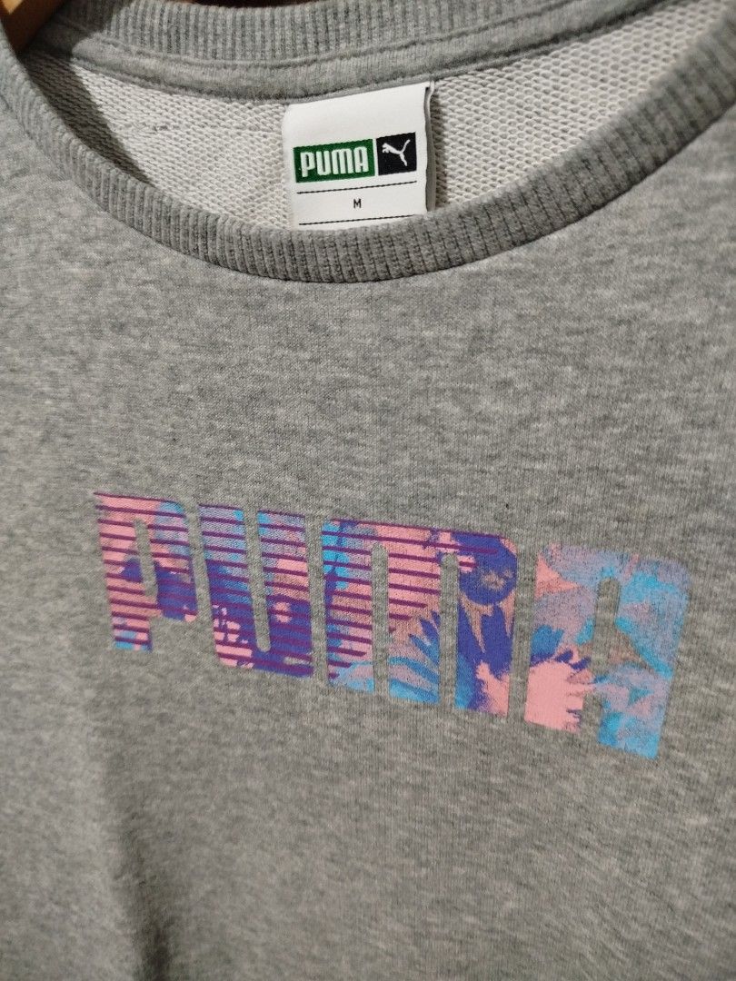 Puma Grey Sweatshirt with Colourful Logo (Category: Coats, Jackets and Outerwear) located in Dipolog. Submitted by x1987 (Listing ID 1441692852, Image 2). Description: - Grey Puma sweatshirt - Features Puma logo with colorful abstract design - Crew neck, long sleeves - Tag indicates size M - Comfortable and casual - Perfect for everyday wear.
