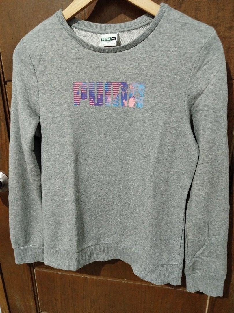 Puma Grey Sweatshirt with Colourful Logo (Category: Coats, Jackets and Outerwear) located in Dipolog. Submitted by x1987 (Listing ID 1441692852, Image 1). Description: - Grey Puma sweatshirt - Features Puma logo with colorful abstract design - Crew neck, long sleeves - Tag indicates size M - Comfortable and casual - Perfect for everyday wear.