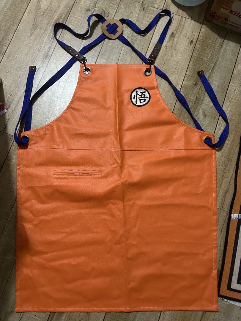 Rare DBZ Dragon Ball Z Goku Inspired Orange Leather Apron (Category: Toys & Games) located in Paranaque City. Submitted by zac.sei (Listing ID 1441712399, Image 1). Description: - Orange apron featuring the iconic Goku Kanji symbol. - Classy and awesome look - Adjustable straps with stylish leather accents. - Convenient chest pocket and a small front pocket. - Ideal for both cooking enthusiasts and cosplay fans. - Made from durable, easy-to-clean