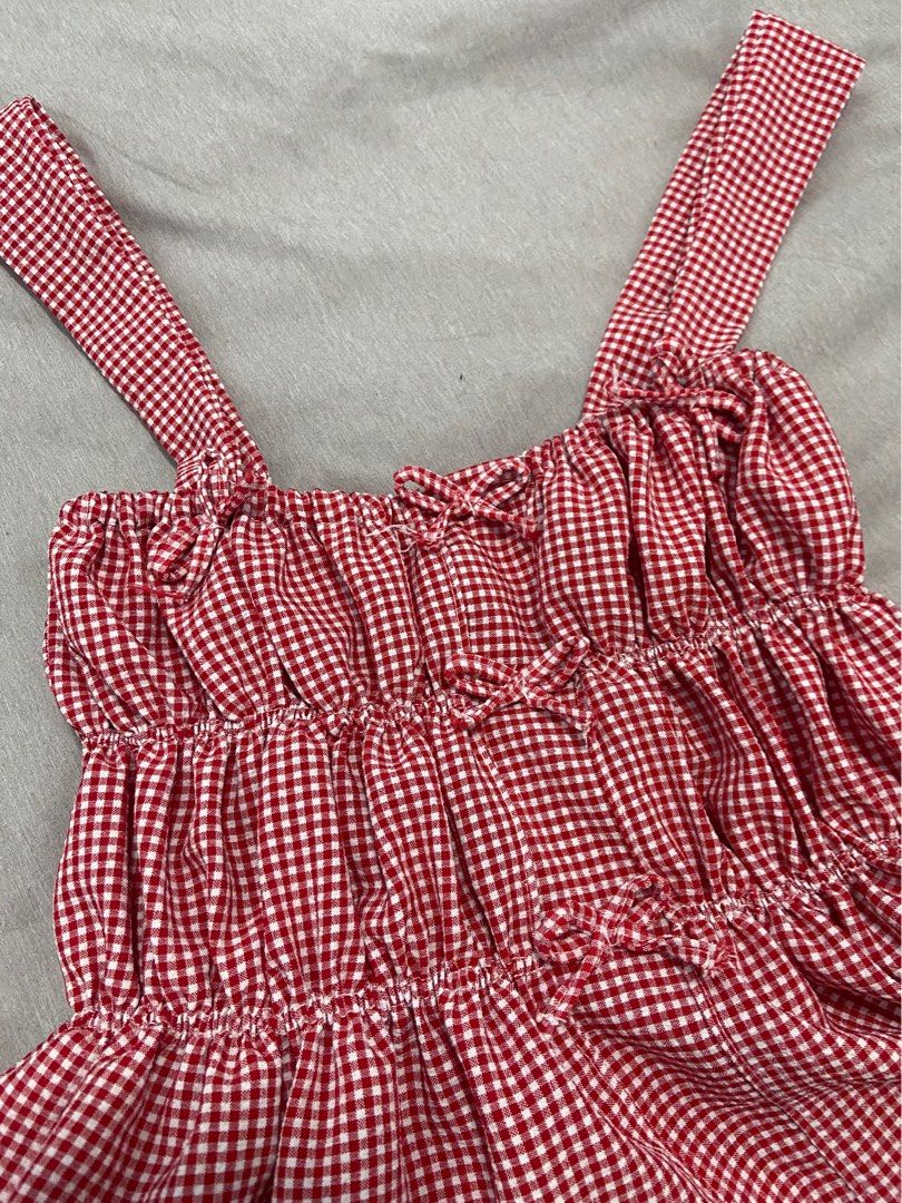 Red Gingham Smocked Peplum Tank Top (Category: Sleeveless) located in Manila. Submitted by nhclknt (Listing ID 1441747455, Image 3). Description: - Adorable red gingham print - Smocked bodice for a comfortable fit - Flirty ruffled trim - Flattering peplum hem - Adjustable straps for a custom fit - Ideal for summer outfits - Versatile: pairs easily with shorts or skirts - can fit to medium.