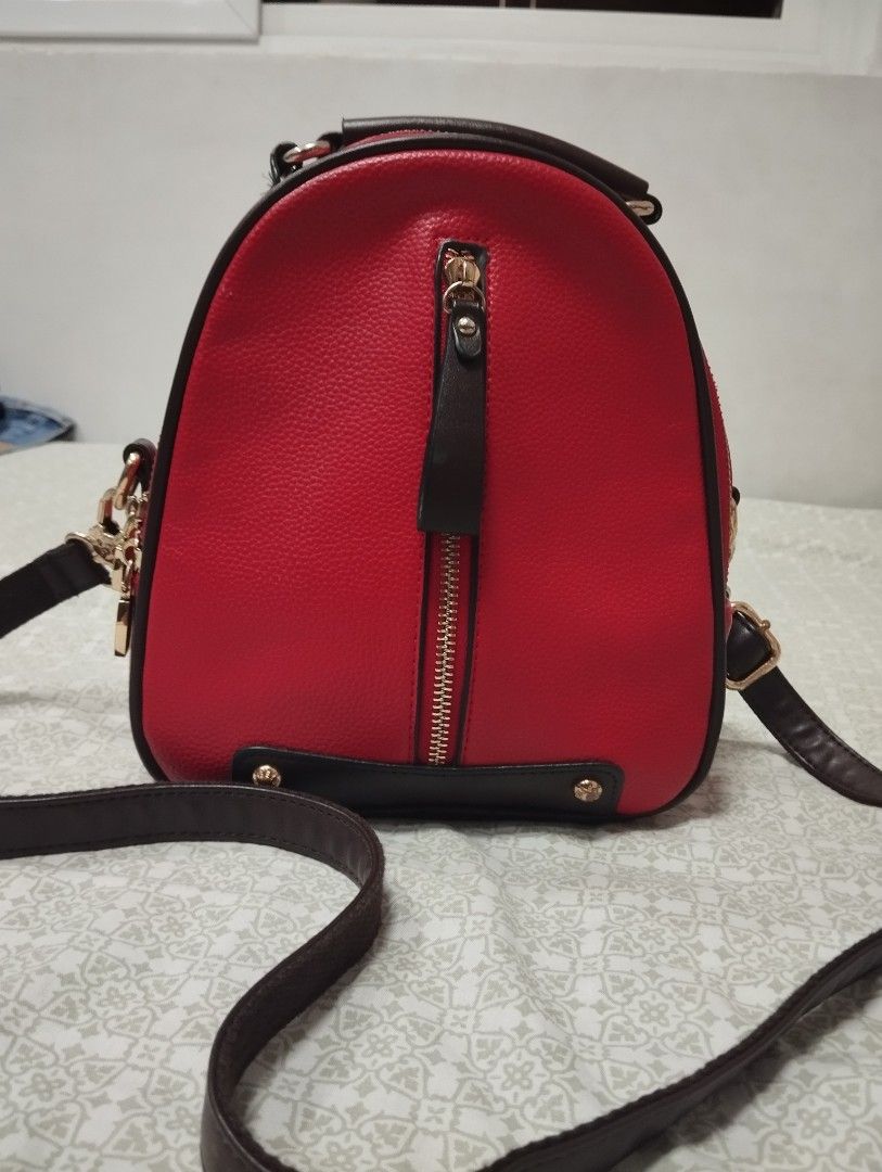 Red Leather Backpack Handbag with Gold Hardware (Category: Luxury Bags & Wallets) located in Dagupan City. Submitted by nartleb_naan (Listing ID 1441635904, Image 1). Description: Preloved - Stylish red leather backpack/shoulder bag - Convenient front zipper pocket - Elegant gold hardware details - Protective metal studs on the bottom - Adjustable straps for comfortable wear - Versatile: wear as a backpack or shoulder bag - Ideal for everyday use