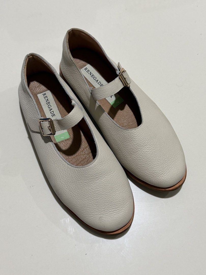 Renegade Folk Mary Janes (Category: Flats & Sandals) located in Bulacan. Submitted by arianecleansupcloset (Listing ID 1441594260, Image 1). Description: - Brand: Renegade Folk - Style: Mary Jane Shoes - Color: Cream - Material: Textured Leather - Features: T-strap with buckle closure - Condition: Soles show some wear - Ideal for: Comfortable and stylish everyday wear.