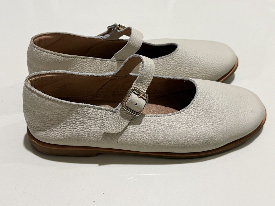 Renegade Folk Mary Janes (Category: Flats & Sandals) located in Bulacan. Submitted by arianecleansupcloset (Listing ID 1441594260, Image 2). Description: - Brand: Renegade Folk - Style: Mary Jane Shoes - Color: Cream - Material: Textured Leather - Features: T-strap with buckle closure - Condition: Soles show some wear - Ideal for: Comfortable and stylish everyday wear.