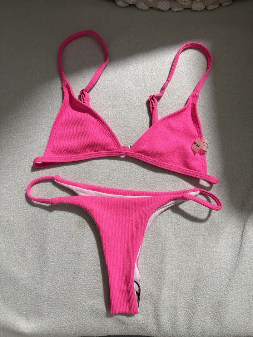 SHEIN Ribbed Neon Pink Bikini Set Size S (Category: Bikinis & Swimsuits) located in Taguig. Submitted by cftbncs (Listing ID 1441697426, Image 2). Description: - Neon pink ribbed bikini set from SHEIN - Triangle top with adjustable straps - Thong bottoms - Material: 82% Polyester, 18% Spandex - Size: S - Care: Wash dark colors separately - no foam.