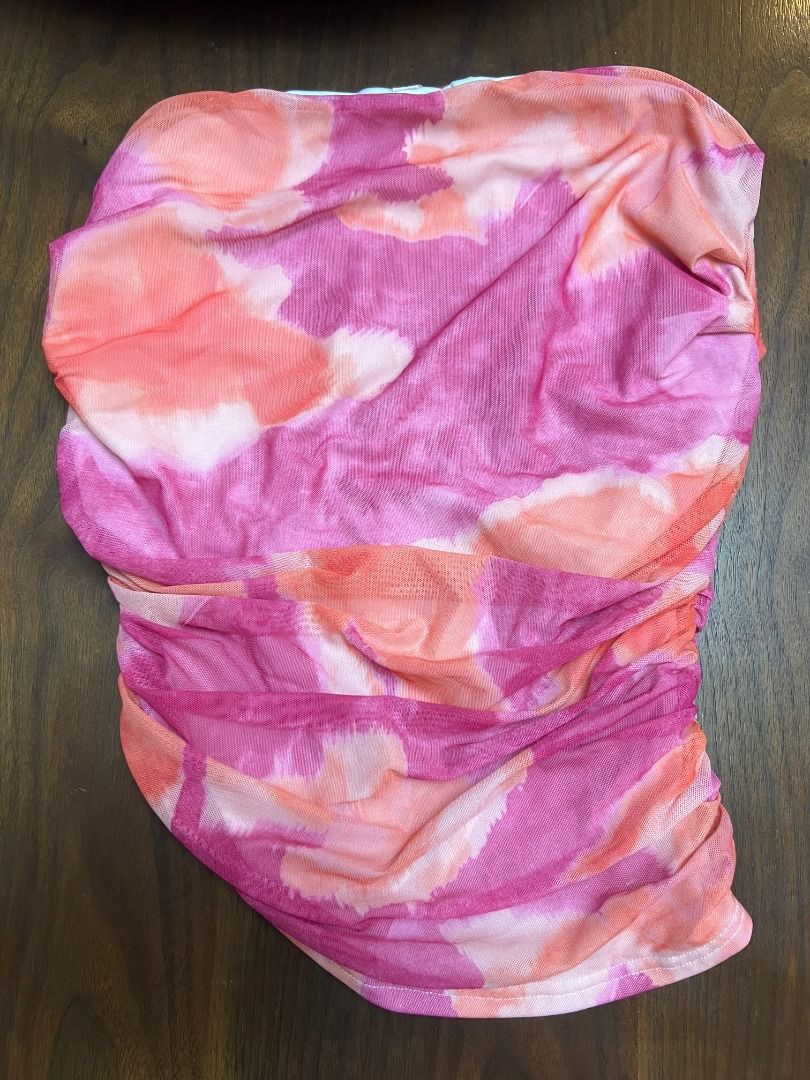 Shein Tie-Dyed Asymmetric Hemline Ruched Top (Category: Sleeveless) located in Quezon City. Submitted by annemargarethh (Listing ID 1441730657, Image 1). Description: - Brand: Shein - Style: Tie-Dyed Asymmetric Hemline Ruched Top - Color: Pink and orange tie-dye pattern - Design: Features ruching for a flattering fit and an eye-catching asymmetric hemline - Material: Lightweight, mesh but not see through.