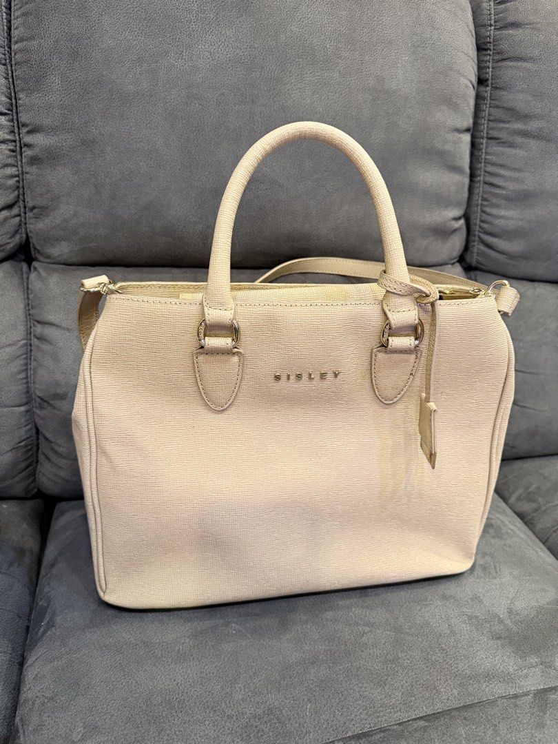 Sisley Beige Textured Tote Bag with Shoulder Strap (Category: Shoulder Bags) located in Valenzuela. Submitted by laureenishappy (Listing ID 1441739196, Image 2). Description: Beige tote bag from Sisley. Textured material. Has top handles and a detachable shoulder strap. Features zip pockets on the front and back. Gold hardware details. Spacious interior. Great for daily use..