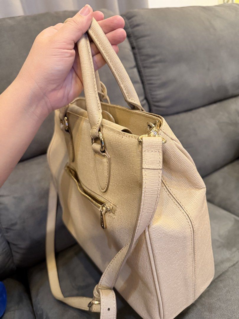 Sisley Beige Textured Tote Bag with Shoulder Strap (Category: Shoulder Bags) located in Valenzuela. Submitted by laureenishappy (Listing ID 1441739196, Image 3). Description: Beige tote bag from Sisley. Textured material. Has top handles and a detachable shoulder strap. Features zip pockets on the front and back. Gold hardware details. Spacious interior. Great for daily use..
