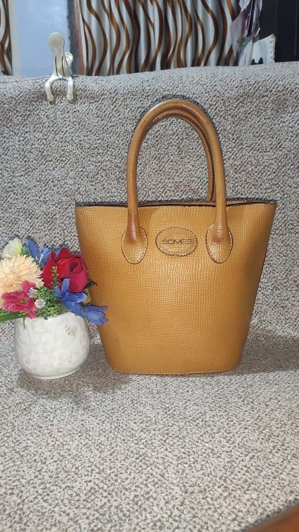 Somes Saddle Camel Leather Bucket Bag (Category: Luxury Bags & Wallets) located in Imus. Submitted by ryanneakiko (Listing ID 1441617001, Image 1). Description: - Somes Saddle bucket bag - Color: Camel - Material: Textured leather - Features: Top handles - Style: Classic piece.