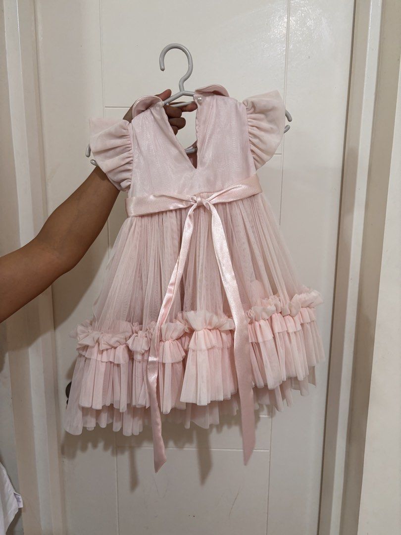 Spinkie Clara Tutu dress (Category: Dresses) located in Pasig City. Submitted by az1235 (Listing ID 1333231683, Image 3). Description: Bought for P4150 at Spinkie SM Megamall Used once (1st bday) No issues Size: 12-18 months Color: powder pink.
