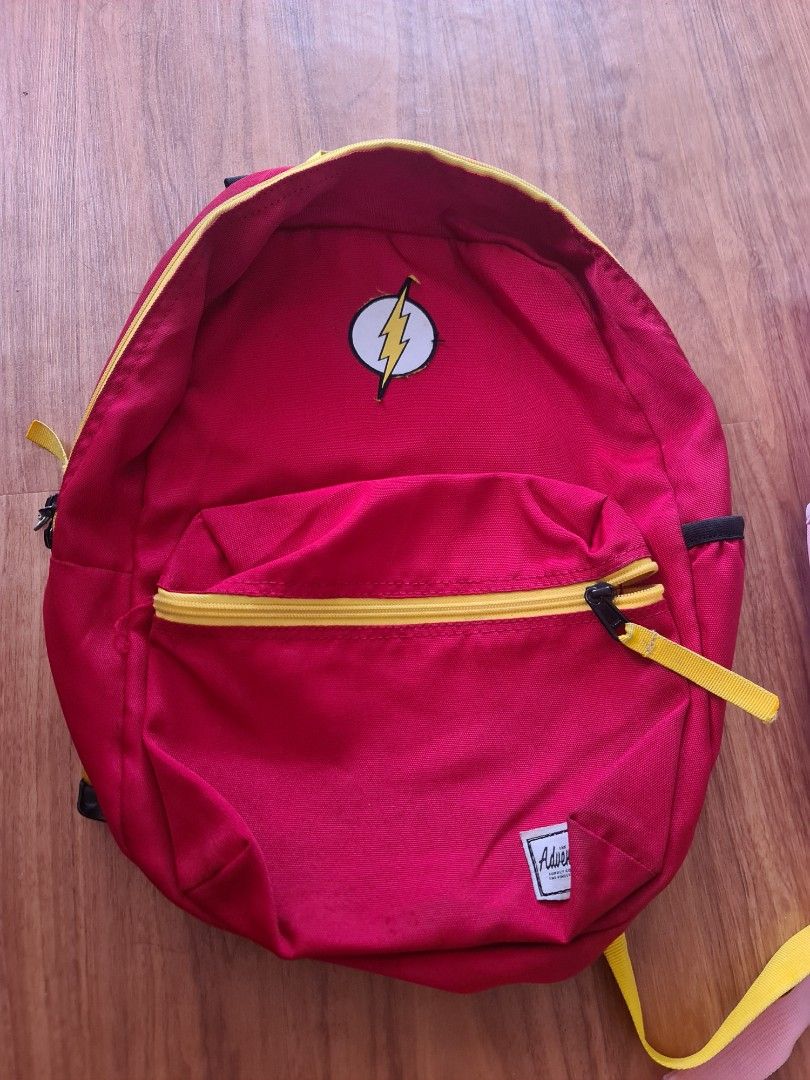The Flash DC Collection Justice League Comics Adventure Prime Backpack (Category: Kids Wardrobes & Storage) located in Manila. Submitted by jenettelim17 (Listing ID 1441609984, Image 1). Description: - Red backpack featuring The Flash logo - Bright yellow zipper and adjustable shoulder straps - Convenient front pocket for extra storage - "Adventure Prime" tag visible - Ideal gift for DC Comics enthusiasts 📍 Pagsikat Place Southern, Muzon, Naic C