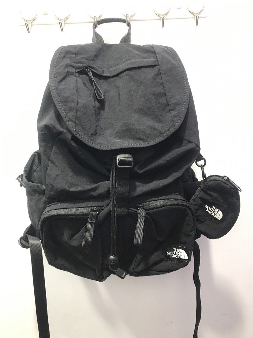 The North Face Black Backpack with Pouch (Category: Backpacks) located in Bamban. Submitted by ukaythriftedkoto (Listing ID 1441731474, Image 1). Description: - Brand: The North Face - Color: Black - Main compartment with drawstring and flap closure - Multiple front pockets for organization - Includes a small, detachable branded pouch on the side - Padded back straps for comfort - Perfect for everyday use, school, or travel.