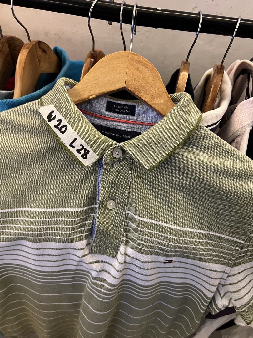 Tommy Hilfiger Striped Polo Shirt Green White (Category: Tshirts & Polo Shirts ) located in Santa Rosa. Submitted by kristine029_86 (Listing ID 1441769682, Image 2). Description: - Brand: Tommy Hilfiger - Color: Green with white horizontal stripes - Fit: Classic Fit - Features: Tommy Hilfiger logo on chest, button-up neckline - Style: Casual wear - Condition: Please check photos for details.