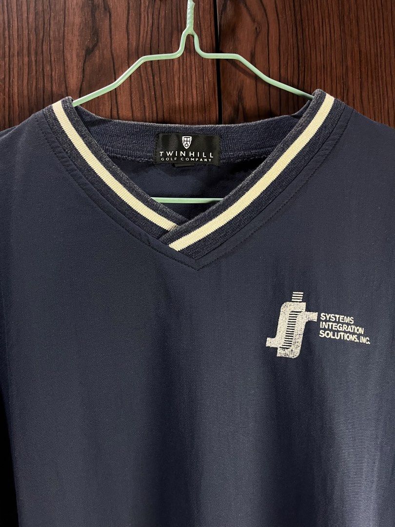 Twin Hill Golf Company Navy V-Neck Pullover (Category: Coats, Jackets and Outerwear) located in Manila. Submitted by chiyooo787 (Listing ID 1441756293, Image 2). Description: 27L by 25W Brand: Twinn Hill Golf Company Color rate: 8/10 Issue: slight discoloration on cuffs but not super noticeable - Navy blue pullover from Twin Hill Golf Company - V-neck with white trim - Logo on left chest and sleeve - Side pockets included - Ideal for golf or casu