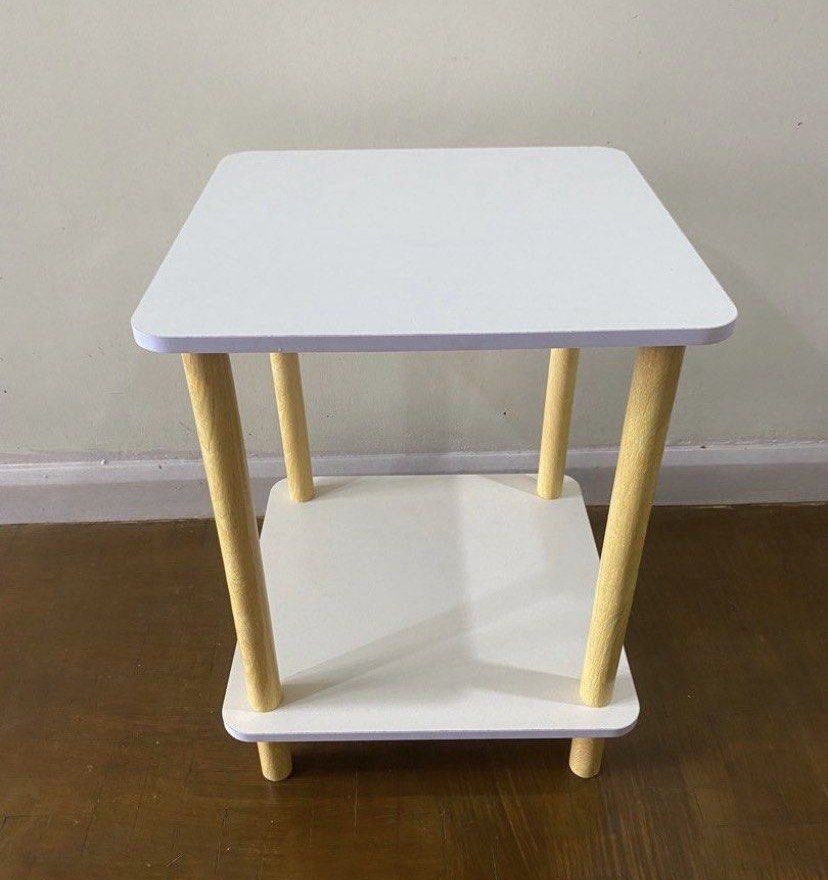 White 2-Tier Side Table with Wooden Legs (Category: Tables & Sets) located in Muntinlupa City. Submitted by bloo_berry (Listing ID 1441648822, Image 1). Description: White 2-layer Nordic Side Table L16” x W16” x H21” Unused, stored Assembled for photo purposes only ₱1,250 SF c/o buyer NO RETURN NO EXCHANGE.