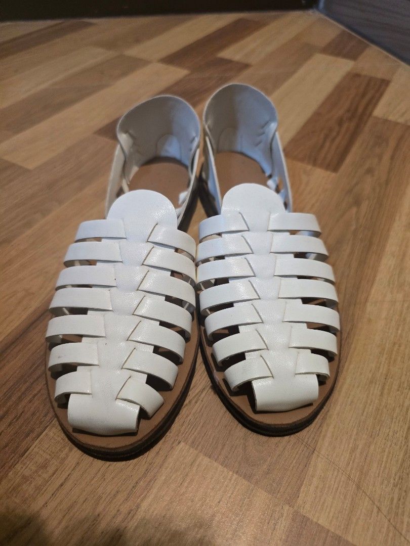 White Woven Strap Flat Sandals (Category: Flats & Sandals) located in Quezon City. Submitted by declutterwithnic (Listing ID 1441771317, Image 2). Description: - Chic white flat sandals - Features a stylish woven strap across the top - Easy slip-on design for convenience - Durable light brown sole - Ideal for comfortable everyday wear and casual outings - Size 5.