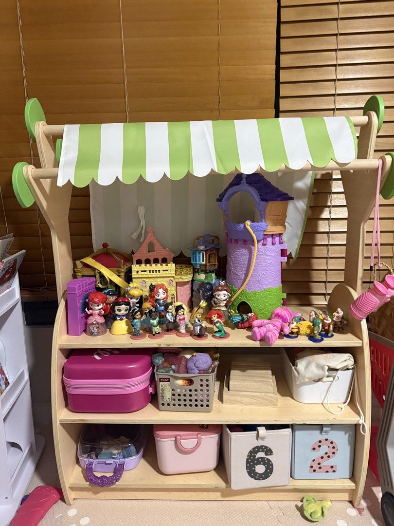 Wooden open shelf toy storage with Canopy (Category: Shelves, Cabinets & Racks) located in Makati City. Submitted by thegarmentcloud (Listing ID 1441598503, Image 2). Description: -hard wood, high quality item -brand: THINKING TOYS - Adorable wooden play stand - Features a charming green and white striped canopy - Perfect for sparking imaginative play - best condition -TOYS ARE NOT INCLUDED.