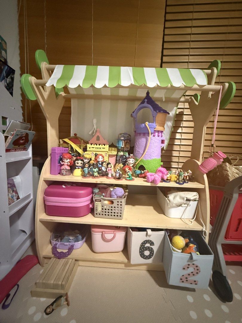 Wooden open shelf toy storage with Canopy (Category: Shelves, Cabinets & Racks) located in Makati City. Submitted by thegarmentcloud (Listing ID 1441598503, Image 1). Description: -hard wood, high quality item -brand: THINKING TOYS - Adorable wooden play stand - Features a charming green and white striped canopy - Perfect for sparking imaginative play - best condition -TOYS ARE NOT INCLUDED.