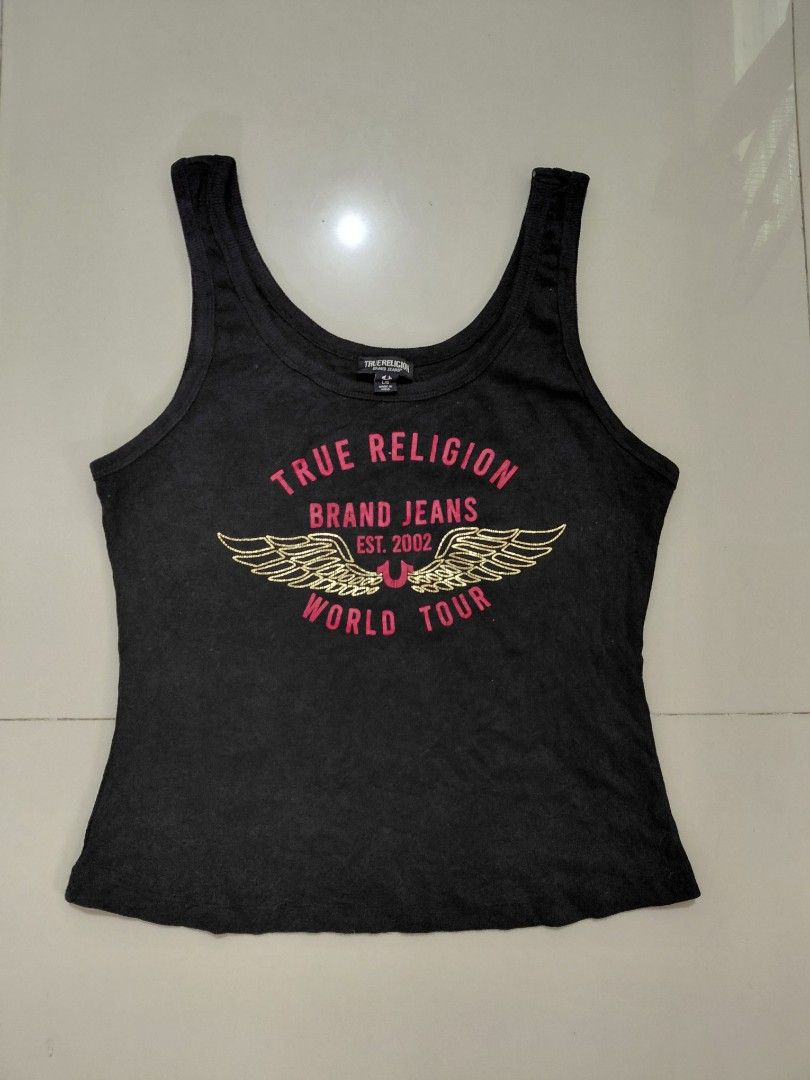 Y2k True Religion World Tour tank tops (Category: Sleeveless) located in Candaba. Submitted by ThrifthingsPH02 (Listing ID 1441610954, Image 1). Description: Y2K True Religion World tour tank top - Features iconic 'World Tour' graphic with wings - Size: L/G on tag -Dimension : 16.5" width armpit to armpit :21" Length top to bottom :16.5" Width bottom - Made in India - Ideal for casual everyday wear Verygood condition Minor Hairline only Php 800 o