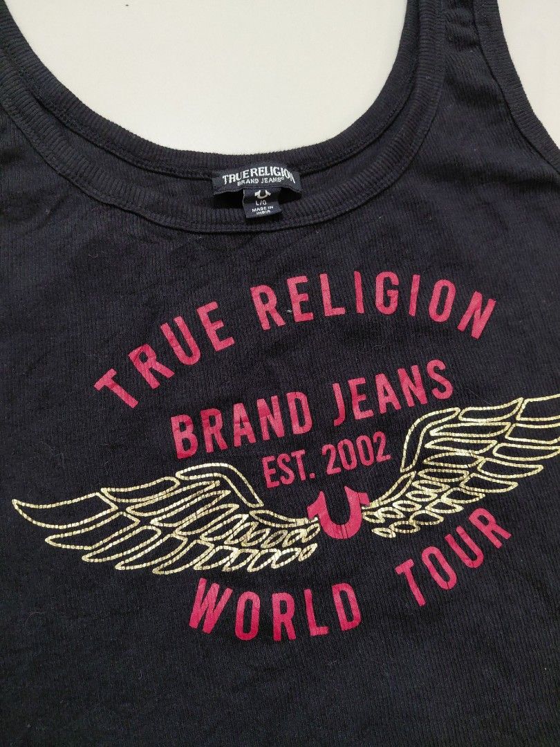 Y2k True Religion World Tour tank tops (Category: Sleeveless) located in Candaba. Submitted by ThrifthingsPH02 (Listing ID 1441610954, Image 3). Description: Y2K True Religion World tour tank top - Features iconic 'World Tour' graphic with wings - Size: L/G on tag -Dimension : 16.5" width armpit to armpit :21" Length top to bottom :16.5" Width bottom - Made in India - Ideal for casual everyday wear Verygood condition Minor Hairline only Php 800 o