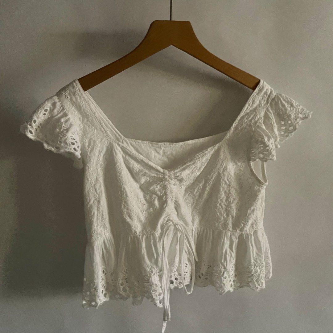 Y2K White Eyelet Square Neck Peplum Top (Category: Sleeveless) located in General Trias. Submitted by 1992thelabel (Listing ID 1441649497, Image 1). Description: - Adorable white eyelet fabric - Flattering square neckline with adjustable drawstring - Chic flutter sleeves - Stylish peplum hem - Versatile: pairs perfectly with jeans or shorts - Ideal for summer outings.