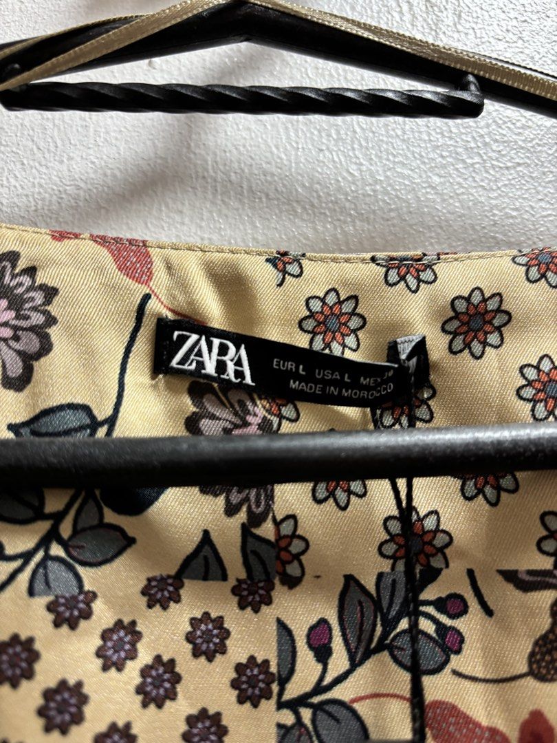 Zara Patchwork Floral Wrap Dress Size L (Category: Dresses) located in Malabon City. Submitted by thriftymanoy (Listing ID 1441637158, Image 2). Description: - Zara Wrap Dress - Size: L - Print: Patchwork Floral - Features: Tie waist, long sleeves, side zipper closure - Fabric: Slight sheen - Style: Dress up or down, versatile.