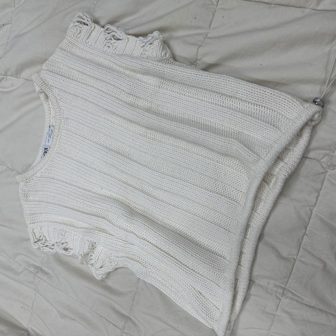 Zara White Knit Cropped Top Size M (Category: Blouses) located in Quezon City. Submitted by _cc_declutters (Listing ID 1441587125, Image 3). Description: - White knit cropped top from Zara - Size: Medium (M) - Features: Ribbed texture - Details: Distressed hem and sleeves - Style: Spaghetti straps - Versatile: Pairs well with high-waisted jeans or skirts.