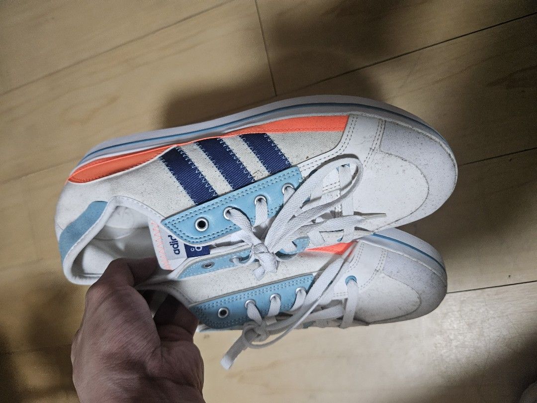 Adidas Canvas Sneakers White Blue Orange (Category: Casual Shoes) located in Lucban. Submitted by bered (Listing ID 1446831257, Image 2). Description: - Adidas canvas sneakers - Color: White with blue stripes and orange accents - Size: UK 10 / US 10 / FR 44 - Made in Vietnam - Ideal for casual wear need funds.