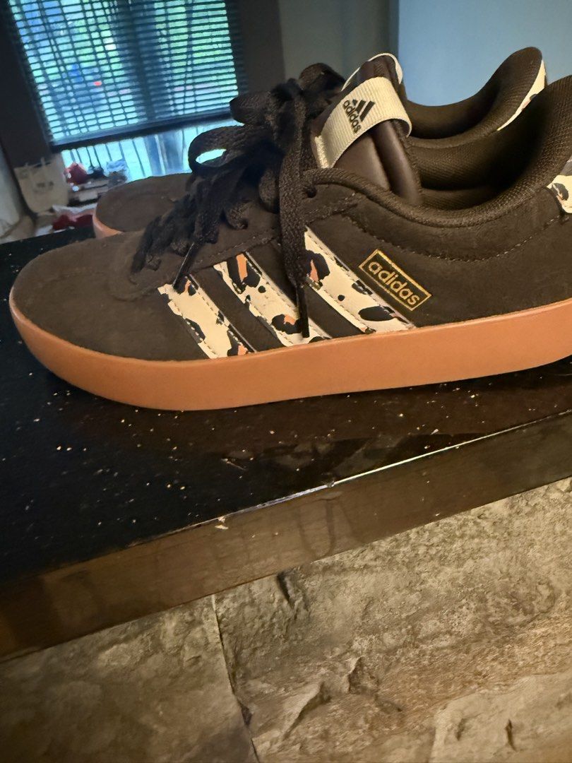Adidas Sneakers with Leopard Print Accents (Category: Sneakers) located in Quezon City. Submitted by therealtigermom (Listing ID 1446818270, Image 3). Description: - Adidas sneakers - Dark brown suede-like exterior - Classic three stripes with leopard print design - Gum sole - Leopard print detail on heel tab - Lace-up closure - Ideal for casual wear.