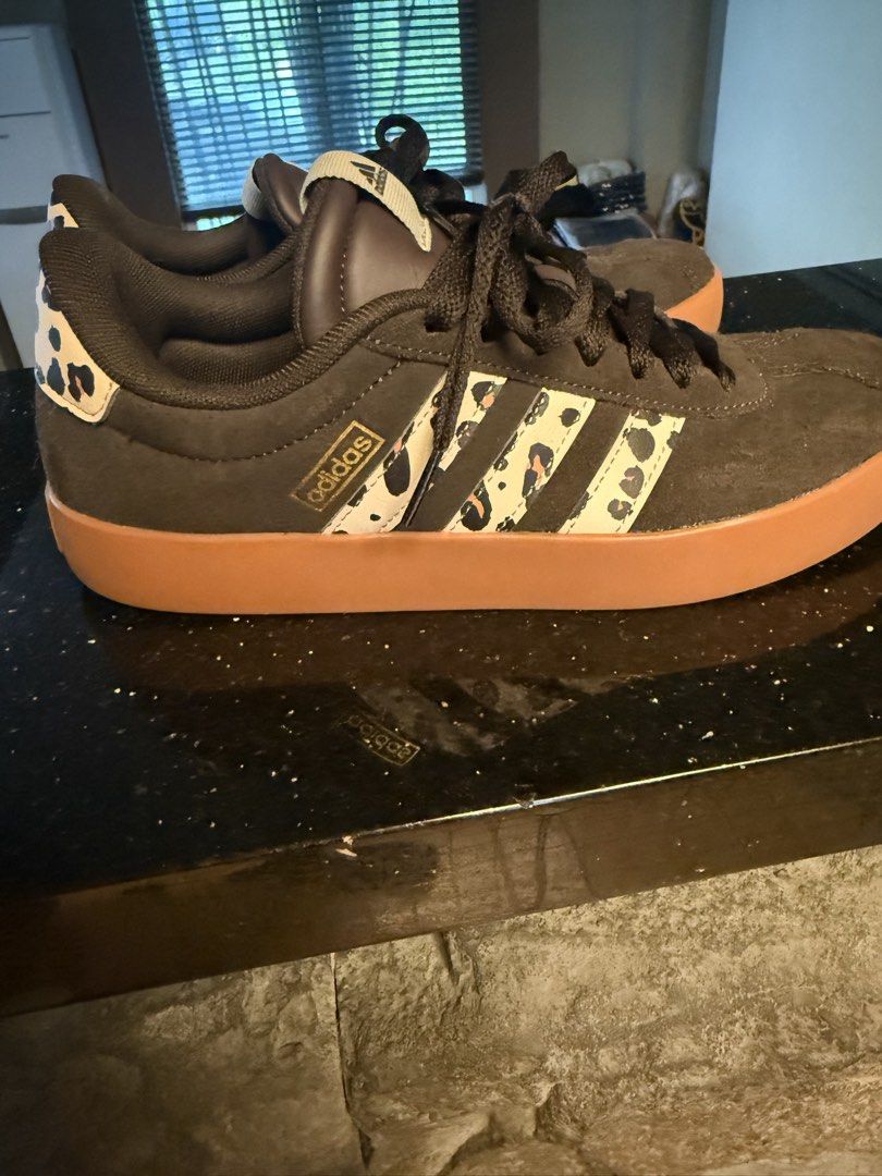 Adidas Sneakers with Leopard Print Accents (Category: Sneakers) located in Quezon City. Submitted by therealtigermom (Listing ID 1446818270, Image 2). Description: - Adidas sneakers - Dark brown suede-like exterior - Classic three stripes with leopard print design - Gum sole - Leopard print detail on heel tab - Lace-up closure - Ideal for casual wear.