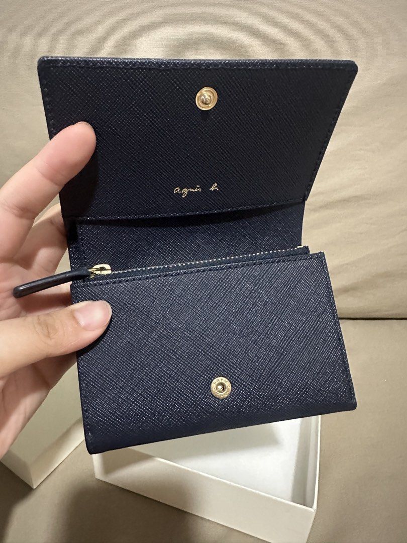 Agnes B. Navy Saffiano Leather Tri-fold Wallet (Category: Wallets & Card holders) located in Rizal. Submitted by trsharchive (Listing ID 1446777972, Image 3). Description: - Brand: Agnes B. - Color: Navy Blue - Material: Saffiano Leather - Hardware: Gold Logo - Design: Tri-fold - Features: Coin zip pocket, card slots - Condition: Brand New. Comes in original box - Original Price: Php12,990.00 - RFS: Gift. I prefer a black wallet .