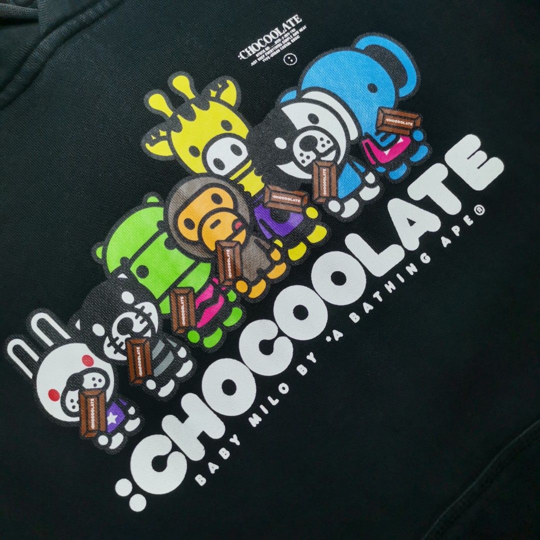 BABY MILO x CHOCOOLATE Black Hoodie (Category: Hoodies) located in Roxas, Palawan. Submitted by mnavt (Listing ID 1446838009, Image 2). Description: - Dimes: 20x26 - Black hoodie with eye-catching graphic print on the front. - Features characters and the 'CHOCOOLATE' logo. - 'MILD BY A BATHING APE' text detail on the hood. - Contrasting white drawstrings. - Ideal for casual and everyday wear..