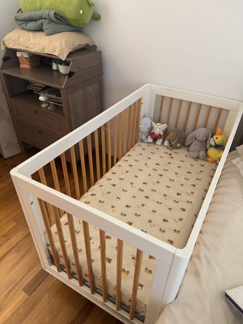 Babyletto Cot (Category: Cots & Cribs) located in Singapore. Submitted by njsb000 (Listing ID 1446733939, Image 3). Description: - White baby crib with natural wood slats - Comes with a fitted sheet (cute animal pattern) - Includes a mattress - Good condition.