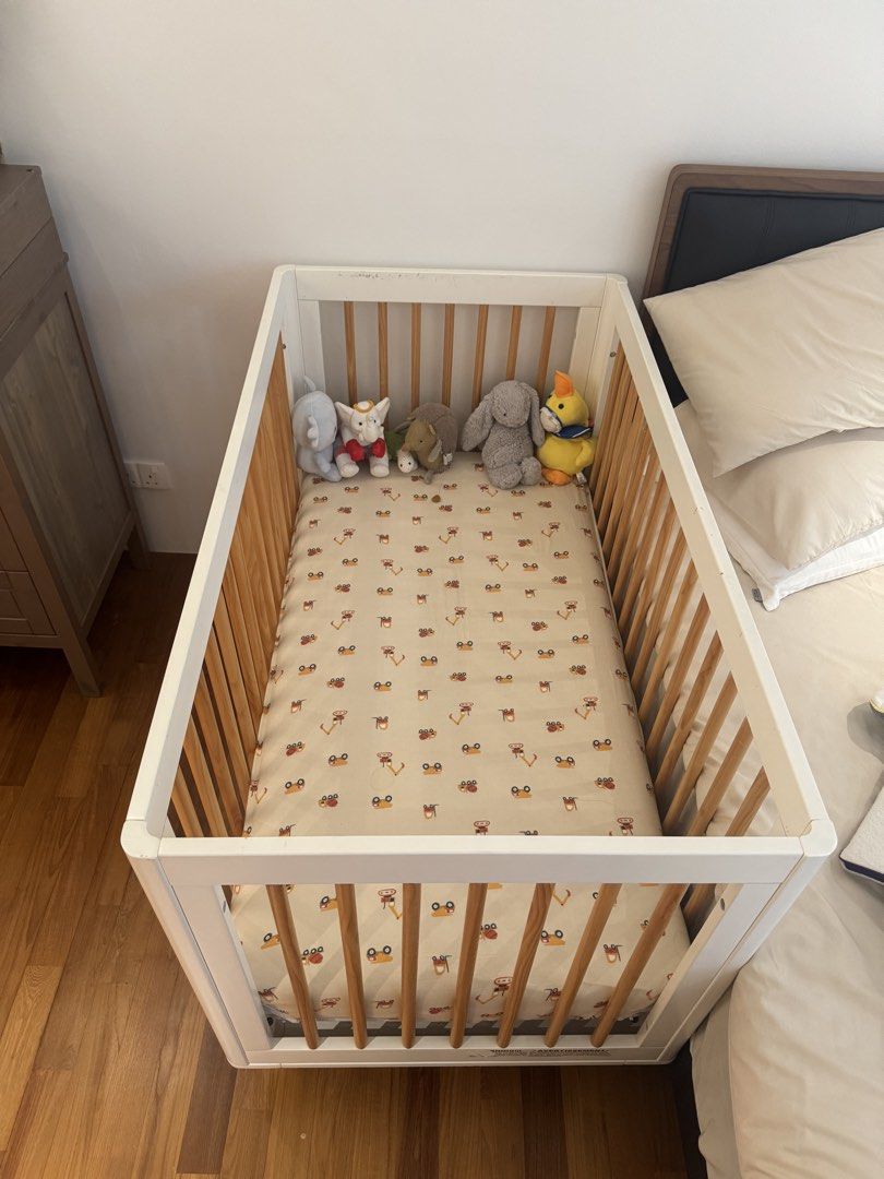 Babyletto Cot (Category: Cots & Cribs) located in Singapore. Submitted by njsb000 (Listing ID 1446733939, Image 2). Description: - White baby crib with natural wood slats - Comes with a fitted sheet (cute animal pattern) - Includes a mattress - Good condition.
