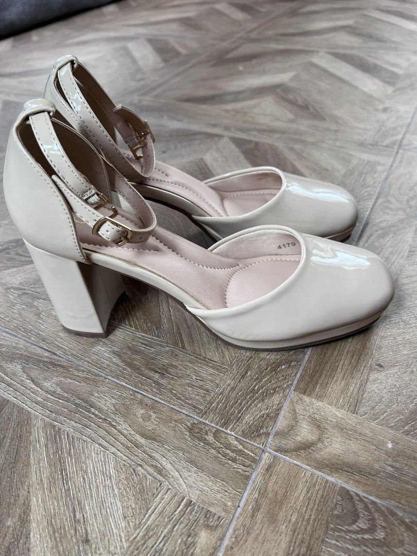 Beige Patent Ankle Strap Block Heels (Category: Heels) located in Quezon City. Submitted by paulinegat (Listing ID 1446779030, Image 2). Description: Selling a pair of beige patent heels. These have an ankle strap with a buckle closure. The block heel is about 2.5 inches high. Worn 2x. They come in their original box. RFS: Decluttering..