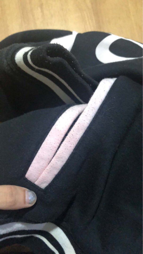 Bershka Black Varsity Jacket "Baller" 44 (Category: Coats, Jackets and Outerwear) located in Manila. Submitted by bojackunicorn (Listing ID 1446740659, Image 3). Description: - Black Bershka varsity jacket - White 'Baller 44' graphic on front - White and pink striped trim on collar, cuffs, and hem - Snap button closure - Two side pockets - Ideal for casual wear Issue: shown on photo, light pink stain.