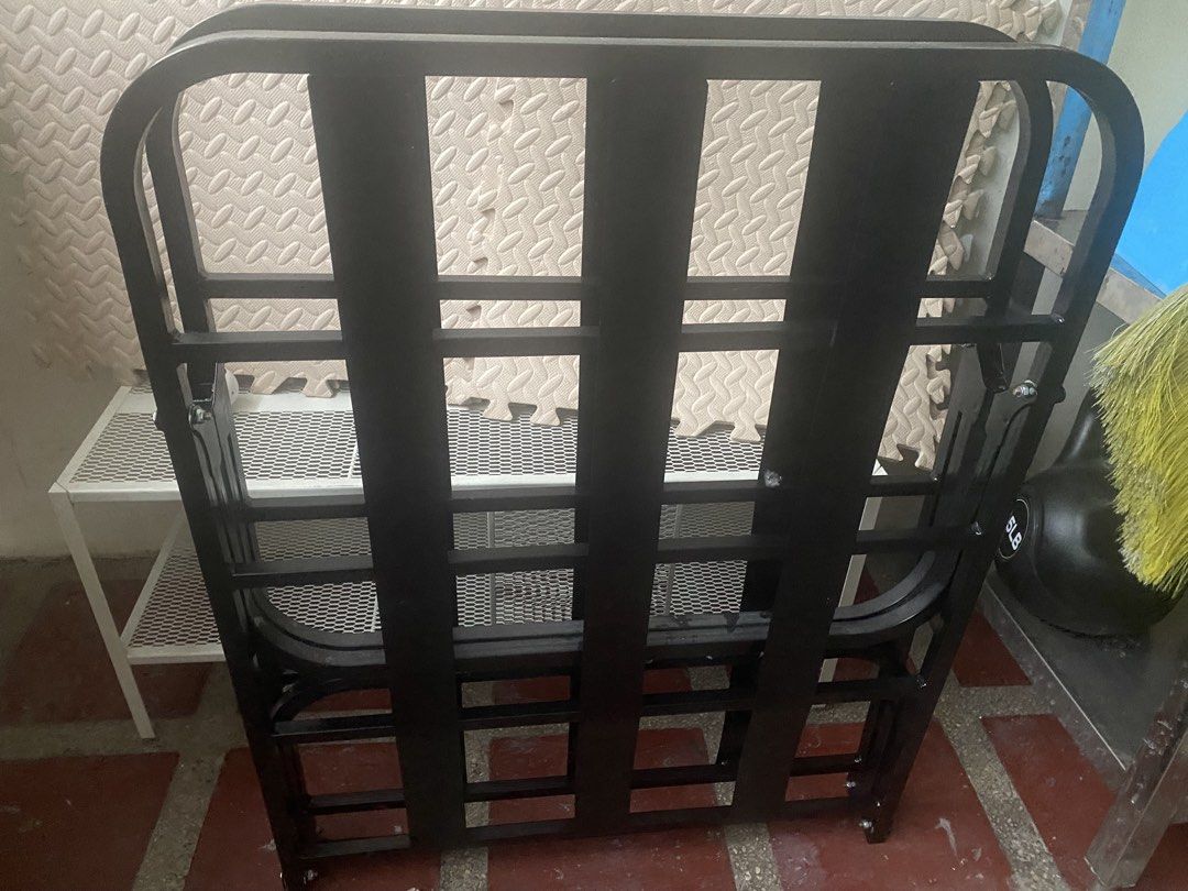 Black Metal Folding Bed Frame (Category: Bed Frames & Mattresses) located in Mandaluyong City. Submitted by minimalist_mak (Listing ID 1446749953, Image 2). Description: - Sturdy black metal folding bed frame - Easy to fold and store - Ideal for guest rooms or small spaces - Suitable for a single mattress - Ready for a new home!.