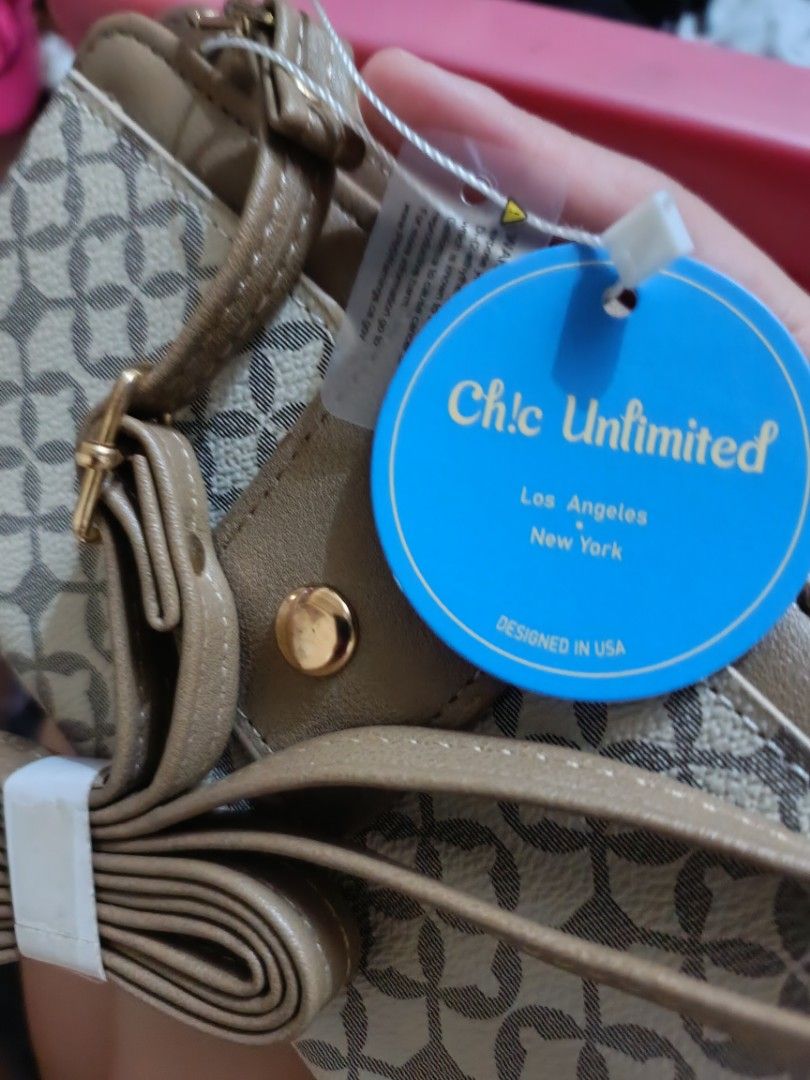 Chic Unlimited Wallet with Strap - Designed in USA (Category: Wallets & Card holders) located in Quezon City. Submitted by JennaMarieD (Listing ID 1446875329, Image 3). Description: - Chic Unlimited brown and beige patterned wallet - Secure snap closure - Convenient zip compartment - Ample card slots and clear ID window - Includes a detachable strap - Proudly made in the USA.