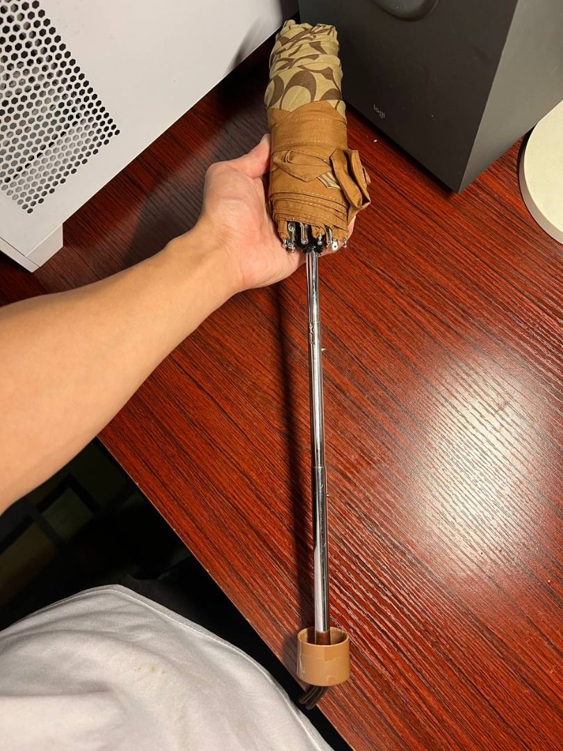 Coach Monogram Folding Umbrella (Category: Umbrellas) located in Baguio. Submitted by carlbenta (Listing ID 1446849403, Image 2). Description: - Classic Coach monogram folding umbrella - Brown and tan pattern - Includes strap for secure folding - Silver handle with brown cap - Compact and easy to carry - Ideal for rainy days Location: Baguio City Shipping: J&T/FLASH/LBC .