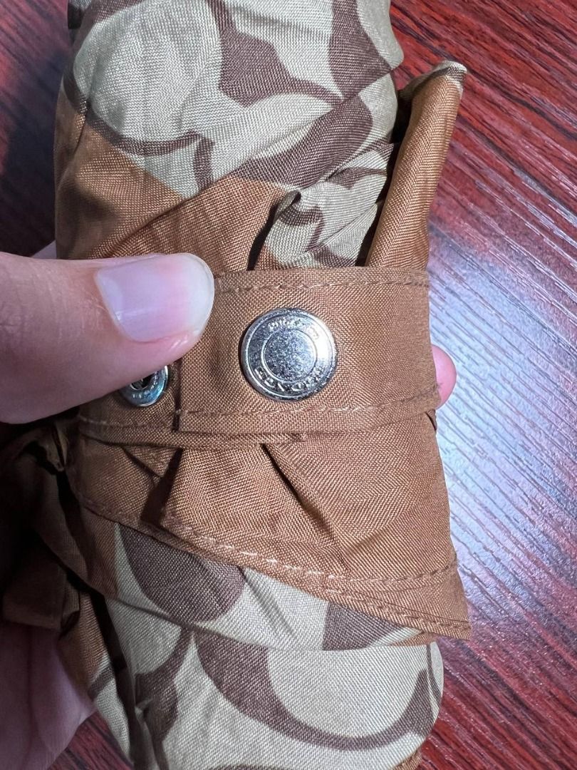 Coach Monogram Folding Umbrella (Category: Umbrellas) located in Baguio. Submitted by carlbenta (Listing ID 1446849403, Image 3). Description: - Classic Coach monogram folding umbrella - Brown and tan pattern - Includes strap for secure folding - Silver handle with brown cap - Compact and easy to carry - Ideal for rainy days Location: Baguio City Shipping: J&T/FLASH/LBC .