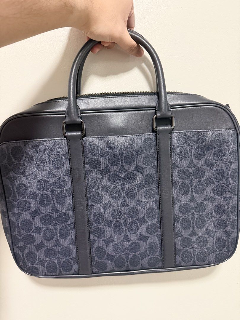 Coach Signature Monogram Leather Briefcase (Category: Briefcases) located in Pasig City. Submitted by xublime.cloud (Listing ID 1446747604, Image 1). Description: Very minimal signs of use RFS: bought a new bag - Classic Coach briefcase - Signature monogram pattern - Leather trim and handles - Zipper closure - Multiple interior compartments for organization - Ideal for work or travel - Includes Coach hang tag.